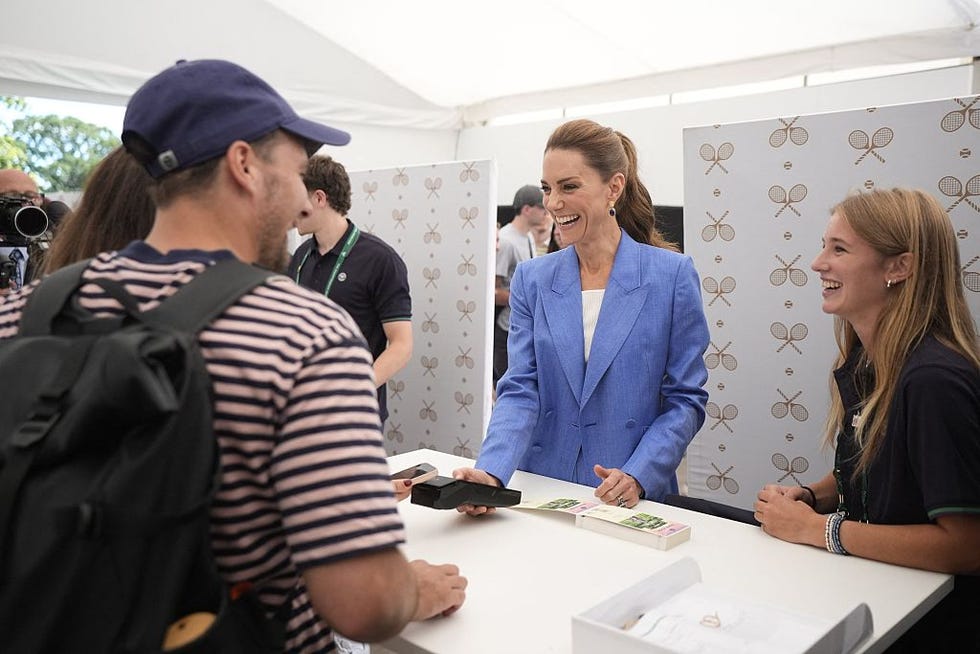 britains catherine, princess of wales (c) helps out in the ticket office as she pays a visit on the fourth day of the 2026 wimbledon championships at the all england lawn tennis and croquet club in wimbledon, southwest london, on july 2, 2026. (photo by andrew matthews / pool / afp via getty images) / restricted to editorial use no commercial use without prior written consent of the aeltc. just still image use no moving images to emulate broadcast. no superimposing or removal of sponsor/ad logos.