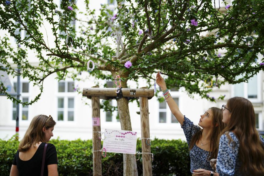 Taylor Swift's fans hang beaded bracelets on a tree in Vienna, Austria, after three of her scheduled concerts were canceled after officials uncovered a plot to attack the concert series.