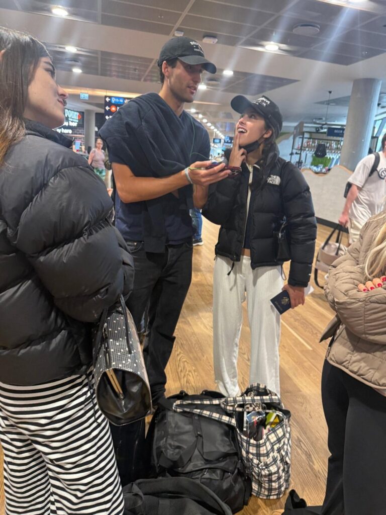 Olivia Rodrigo pictured at the airport with her team and rumoured beau, Julian Croonenberghs, leaving Iceland and returning to New York