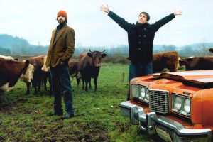 UNITED STATES - JANUARY 01: CARNATION Photo of MOUNTAIN GOATS and Peter HUGHES and John DARNIELLE, Posed group portrait of Peter Hughes (L) and John Darnielle on a farm with cows and a car (Photo by Steven Dewall/Redferns)
