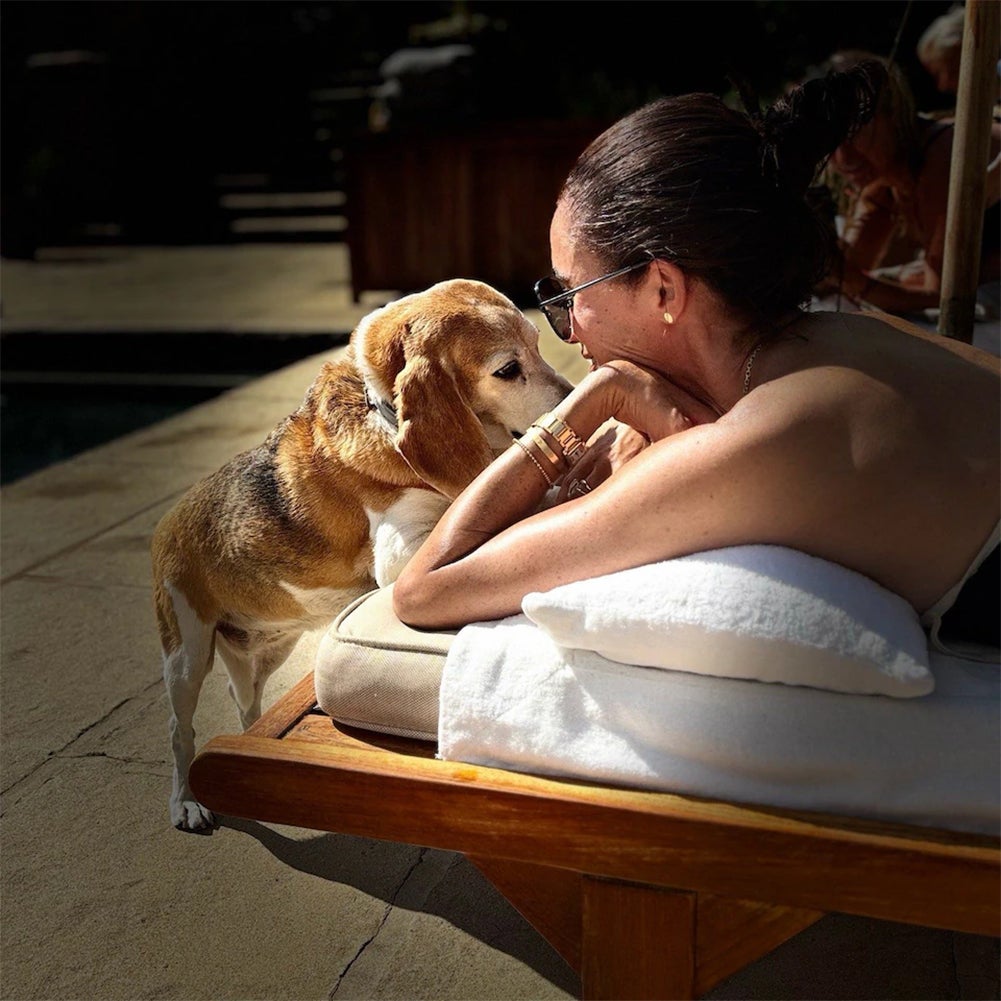 Meghan enjoys some time in the sun with a furry friend