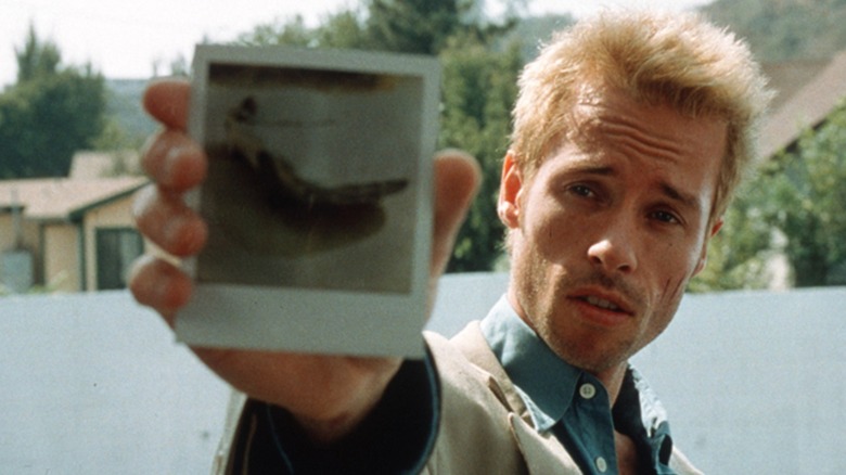Leonard holding up a polaroid in Memento