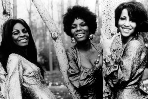 UNSPECIFIED - JANUARY 01: Photo of Rosalyn ASHFORD and Martha REEVES + The Vandellas and Martha REEVES and Betty KELLY; Posed group half length portrait. In woods, leaning on trees, smiling to camera. L - R: Rosalyn Ashford, Betty Kelly, Martha Reeves (Photo by Echoes/Redferns)