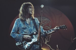 Canadian singer-songwriter Neil Young performs on stage with Crazy Horse at Hammersmith Odeon, London, 28th March 1976. (Photo by Michael Putland/Getty Images)