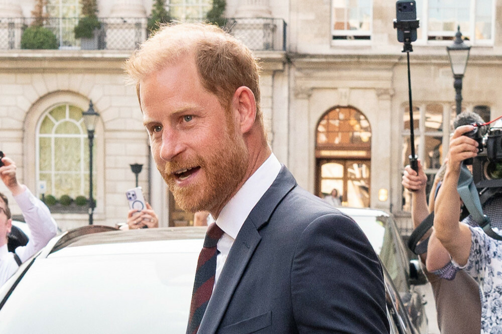 Prince Harry has ended a whirlwind return to the UK by swapping royal formality for goat yoga, inflatable obstacle courses and water bomb fights as he joined bereaved military children at a summer festival in Warwickshire