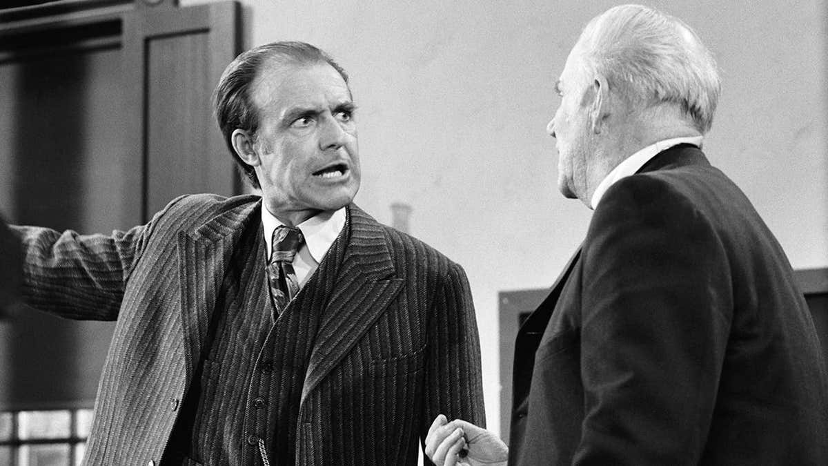 Richard Bull as Nels Oleson and Dabbs Greer as Reverend Robert Alden stand together in a scene.