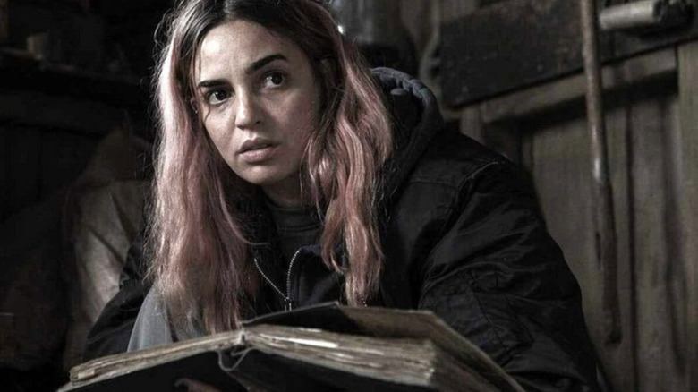 Alice does some light reading in Evil Dead Burn