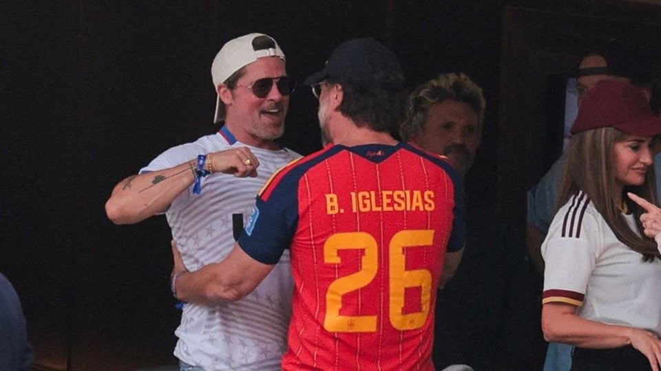 Javier Bardem and Penélope Cruz embrace POS Brad Pitt at the Spain v Belgium match