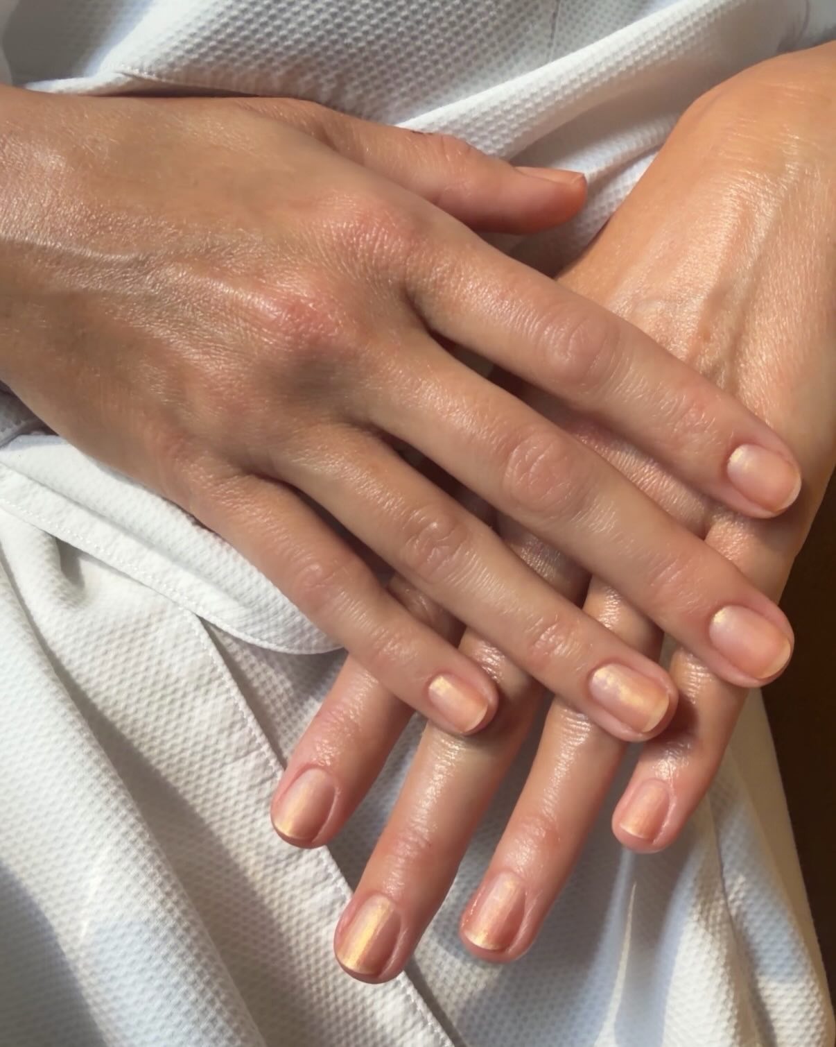 A close-up of Margot Robbie's gold manicure