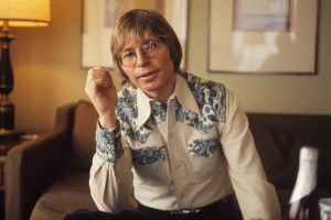 John Denver poses for a portrait in his hotel room in 1979 in Amsterdam, Netherlands. (Photo by Gijsbert Hanekroot/Redferns)