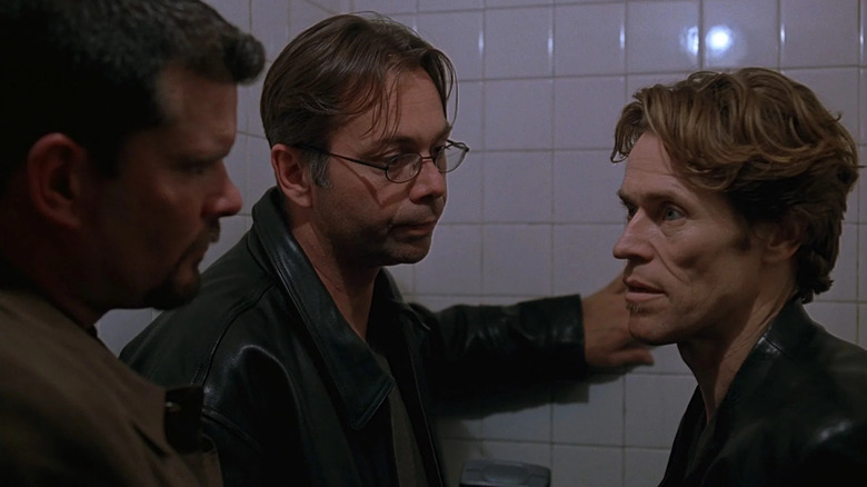 X talking to two guys in New Rose Hotel