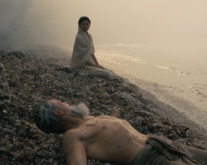 Zendaya's latest look on a beach, sitting with a man lying on the sand, for the tiny detail.