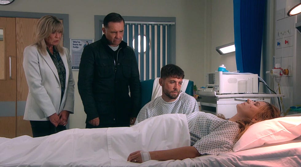 kim tate, graham foster, joe tate and dawn fletcher in a hospital room in emmerdale.