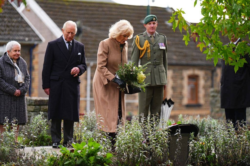 Queen Camilla laying her flowers at the Aberfan Memorial Garden