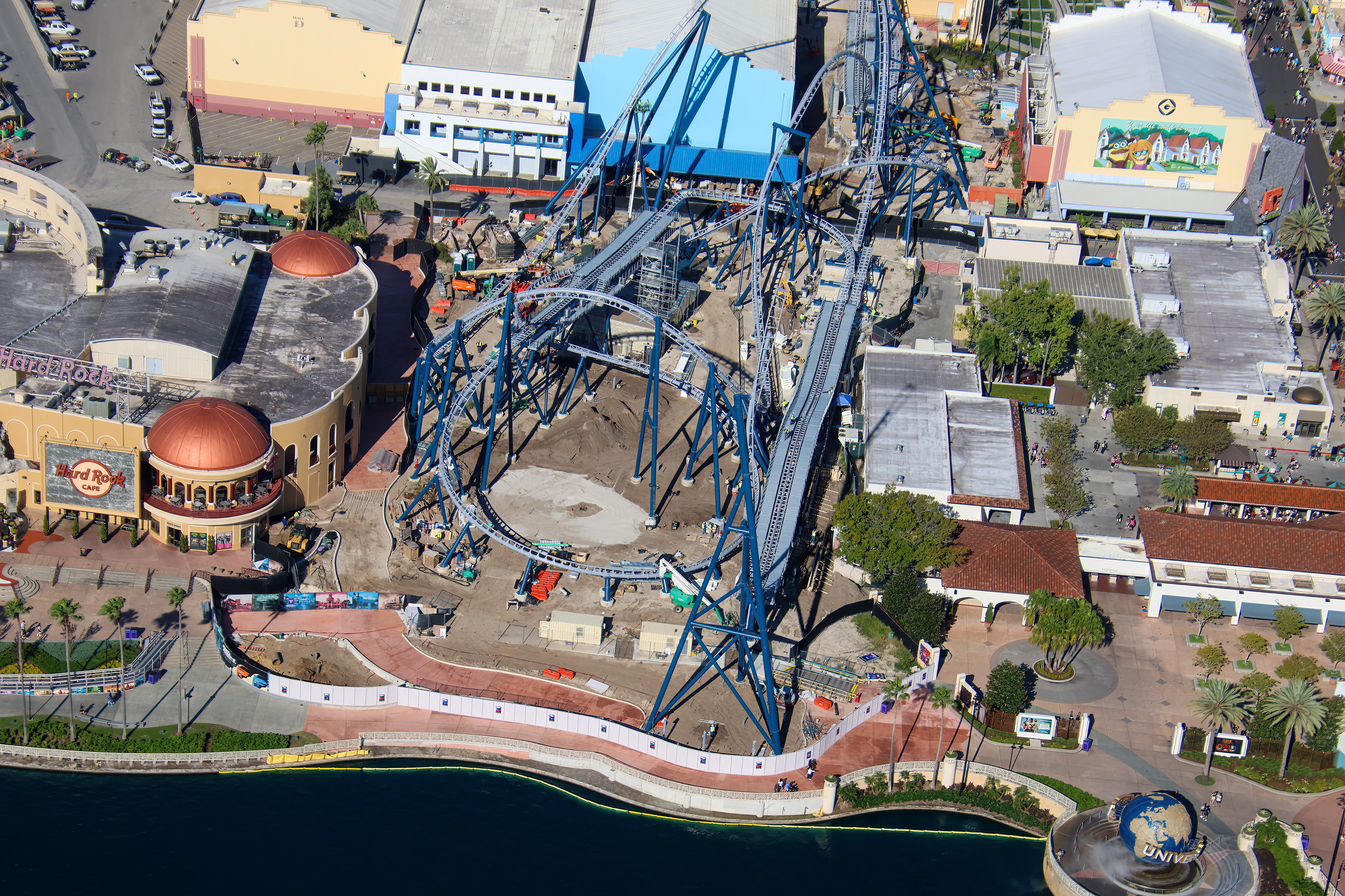 Crews are fine-tuning track components and completing waterfront pavement around Fast & Furious: Hollywood Drift at Universal Studios Florida, as new photos offer a closer look inside the coaster’s station and surrounding construction site.