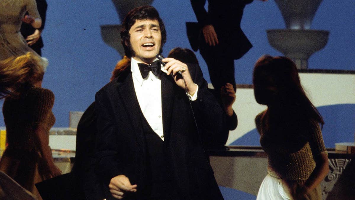 Engelbert Humperdinck stands on stage during a television special.